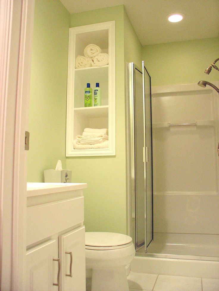 a white toilet sitting next to a walk in shower