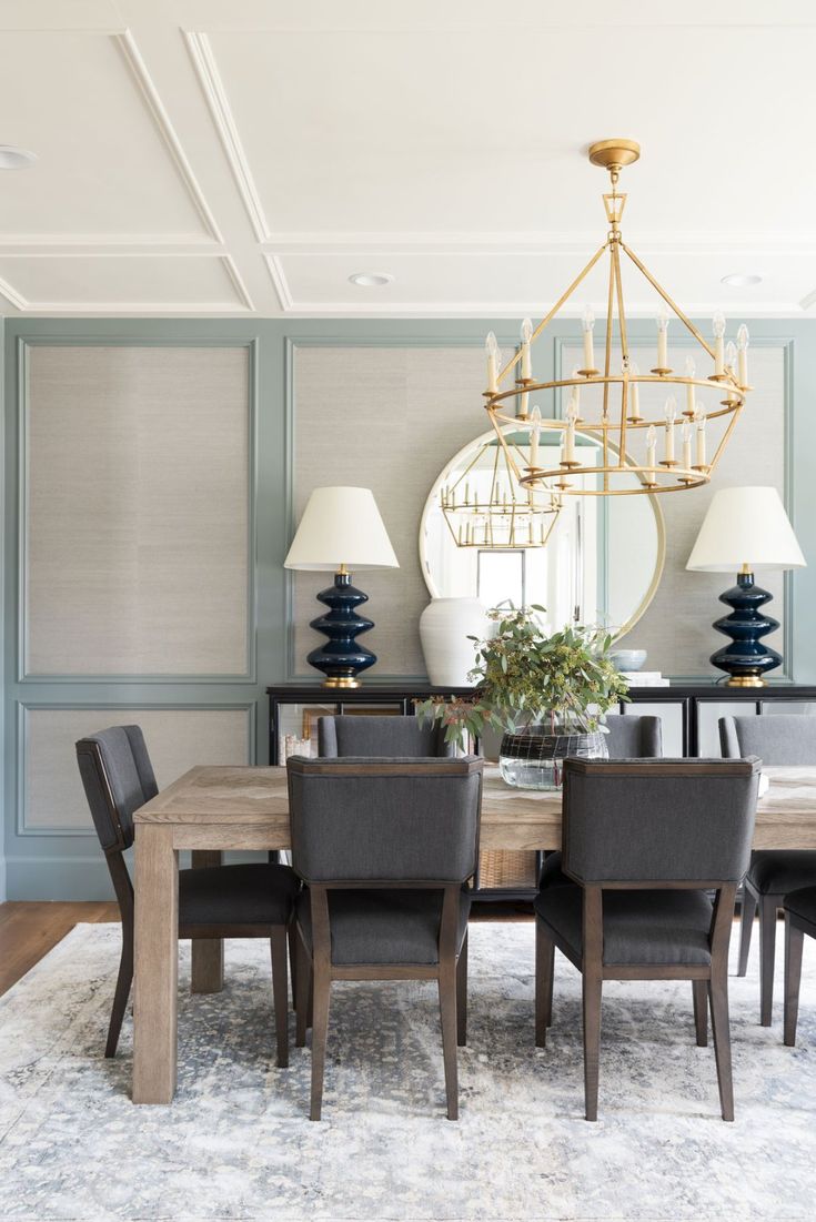 a dining room table with chairs and a chandelier