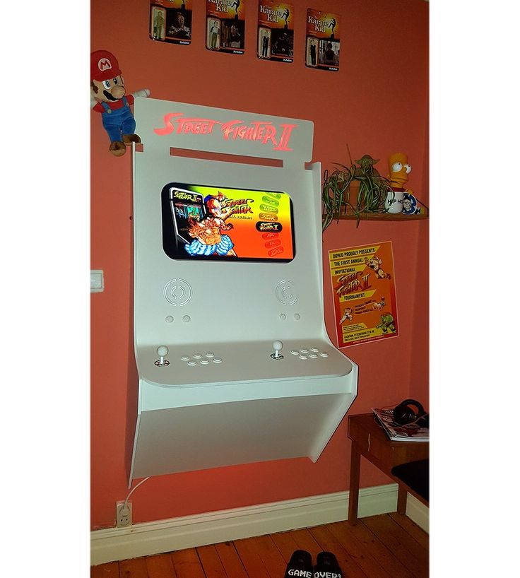 a video game machine mounted to the side of a wall in a child's room