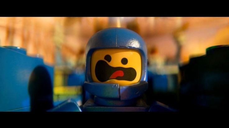 a lego man with a blue helmet and red eyes