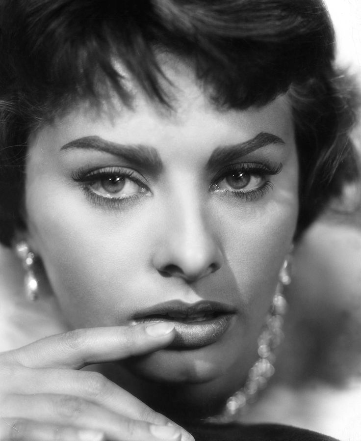 a woman with bright yellow eyes posing for a magazine advertisment in black and white