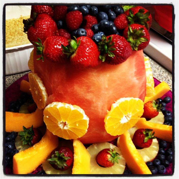 a cake made to look like an apple with fruit on top