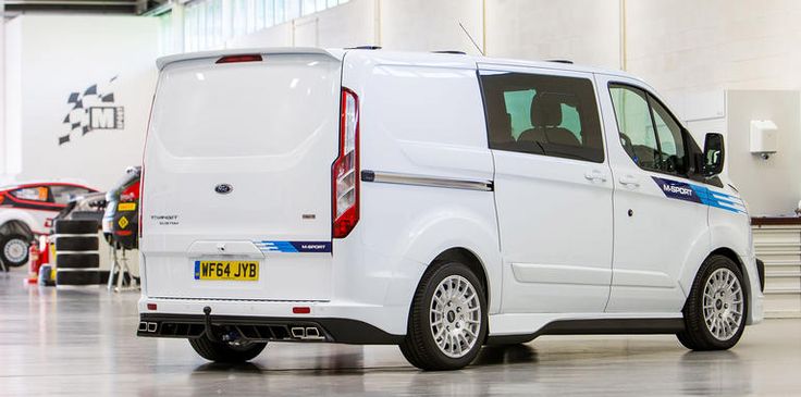 a white ford transit van parked in a garage