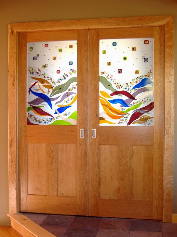 two wooden doors with stained glass designs on them