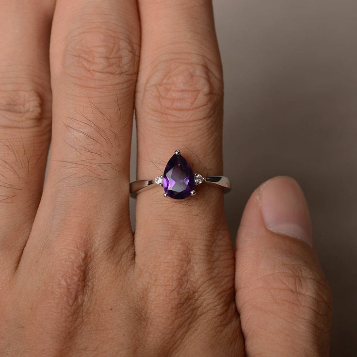 This is a gorgeous handmade creation. Its beauty is its simplicity & Elegance. The 6*9 mm pear shape faceted natural amethyst is crafted in solid sterling silver and with rhodium plated. All item is sent in a beautiful gift box If you have any idea of design your ring,pls contact me directly. You can realize more lovely stuff clicking the link https://www.etsy.com/shop/knightjewelry?refshopsection_shophome_leftnav Please leave the correct address and you phone number for delivering successfu Teardrop Diamond Ring With Gemstone As Gift, Teardrop Diamond Ring With Gemstone For Gifts, Teardrop Solitaire Jewelry For Anniversary, Dainty Teardrop Ring For Anniversary, Dainty Teardrop Anniversary Ring, Teardrop Amethyst Ring For Anniversary, Pear-shaped Amethyst Ring For Anniversary, Teardrop Solitaire Promise Ring, Fine Jewelry Teardrop Crystal Ring For Anniversary