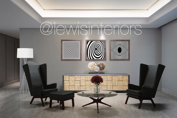 a living room filled with black chairs and a round glass coffee table in front of a painting on the wall