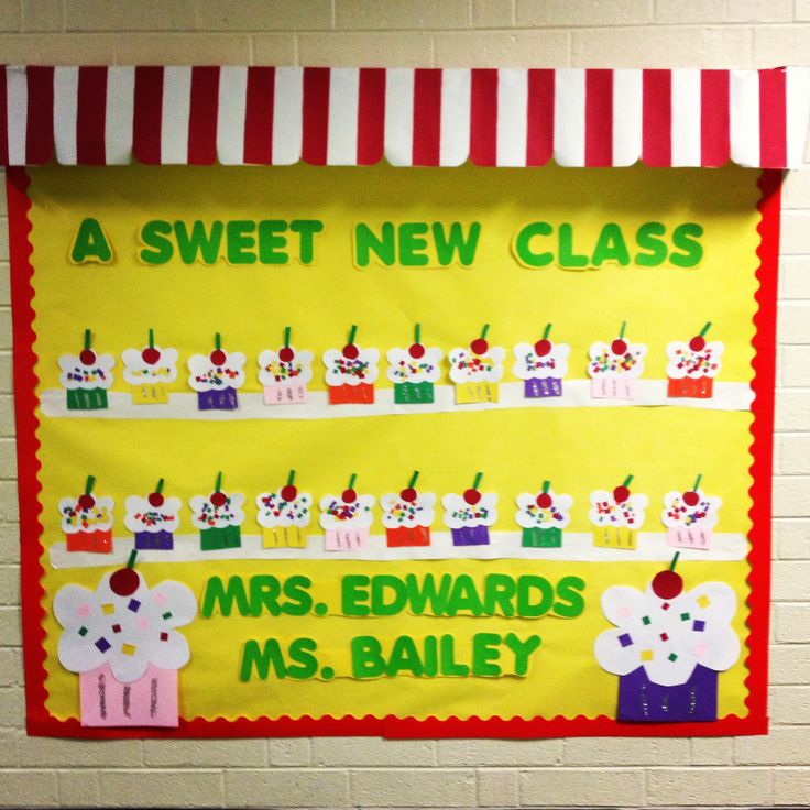 a classroom bulletin board with an apple and cupcake theme