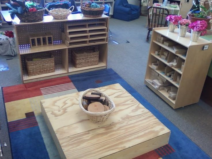 a room filled with lots of wooden shelves and baskets on top of tables in front of bookshelves