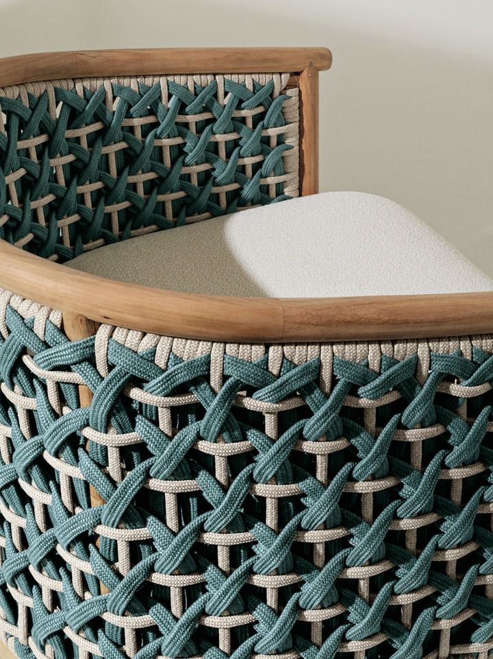 a close up of a woven basket on a wooden table with a white pillow in it