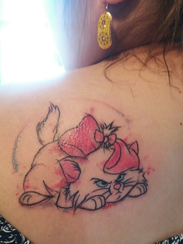 a woman with a cat tattoo on her back