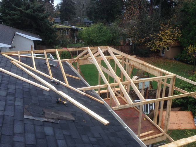 a house being built on top of a roof