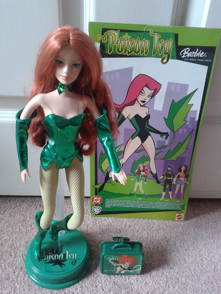 there is a doll with red hair and green clothes next to a box that says possn toy