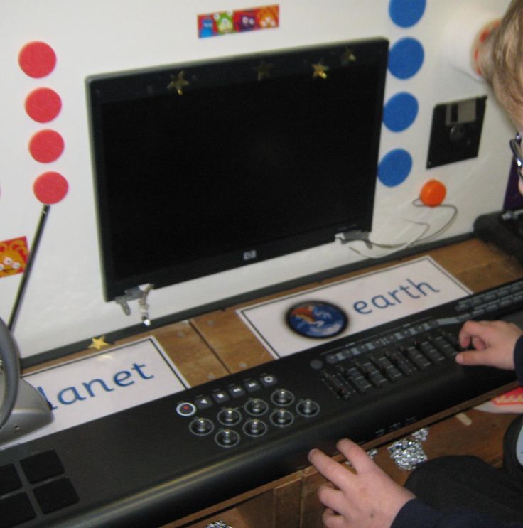 a young boy playing with a computer keyboard