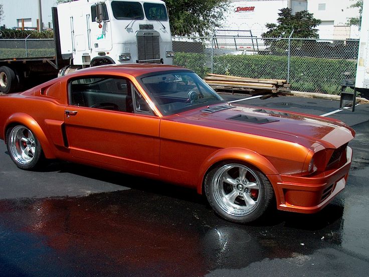 an orange car parked in a parking lot