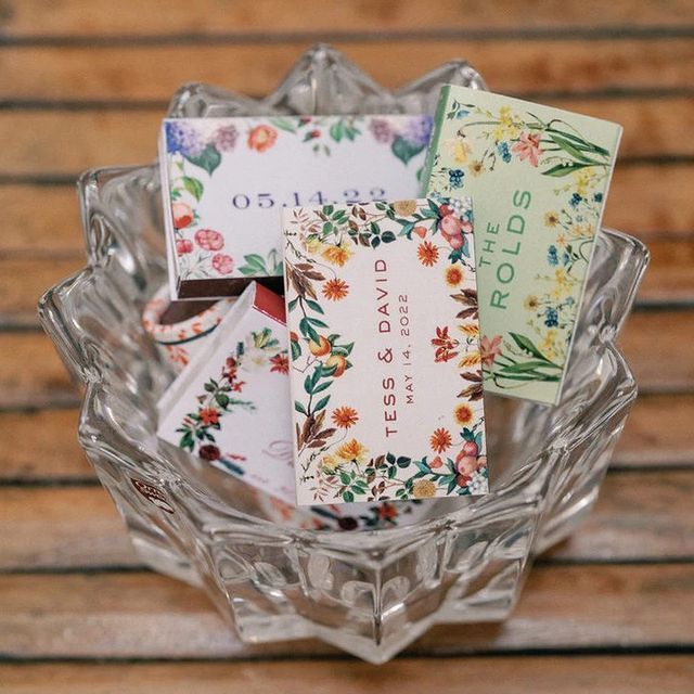 some cards are in a glass bowl on a wooden table