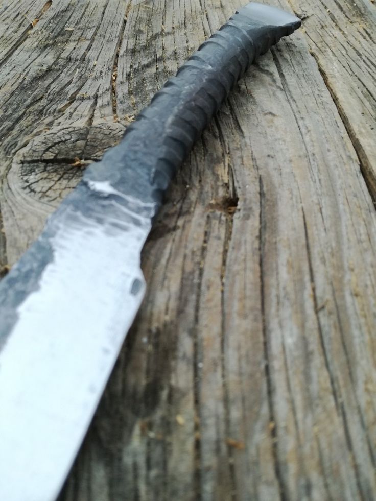 a knife that is laying on top of a piece of wood with it's blade missing