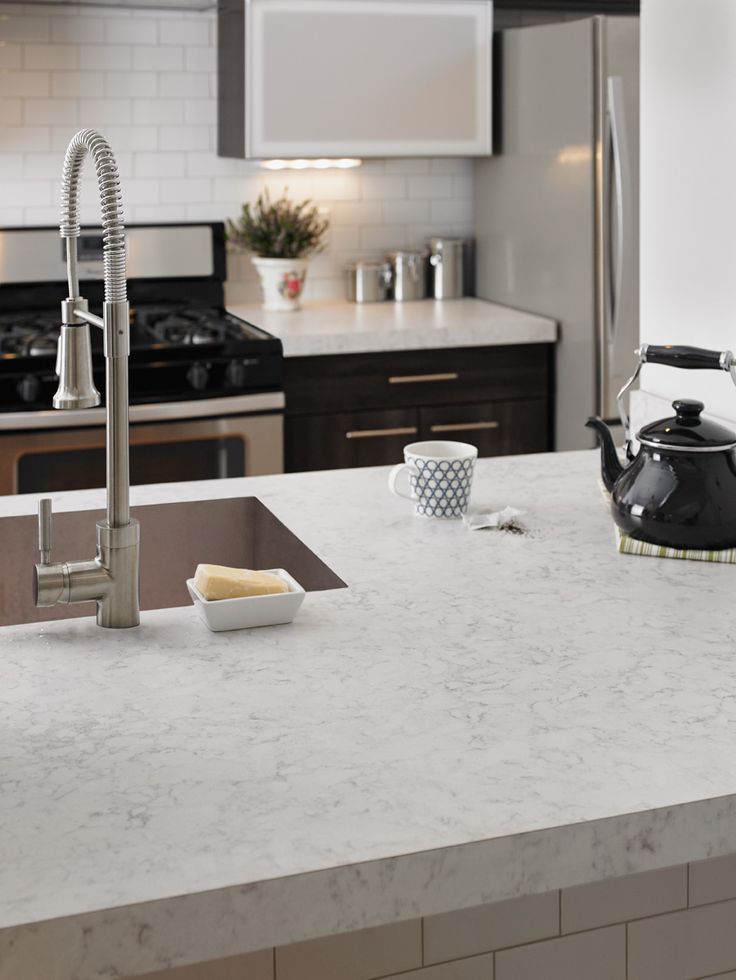 a kitchen counter top with a tea kettle on it