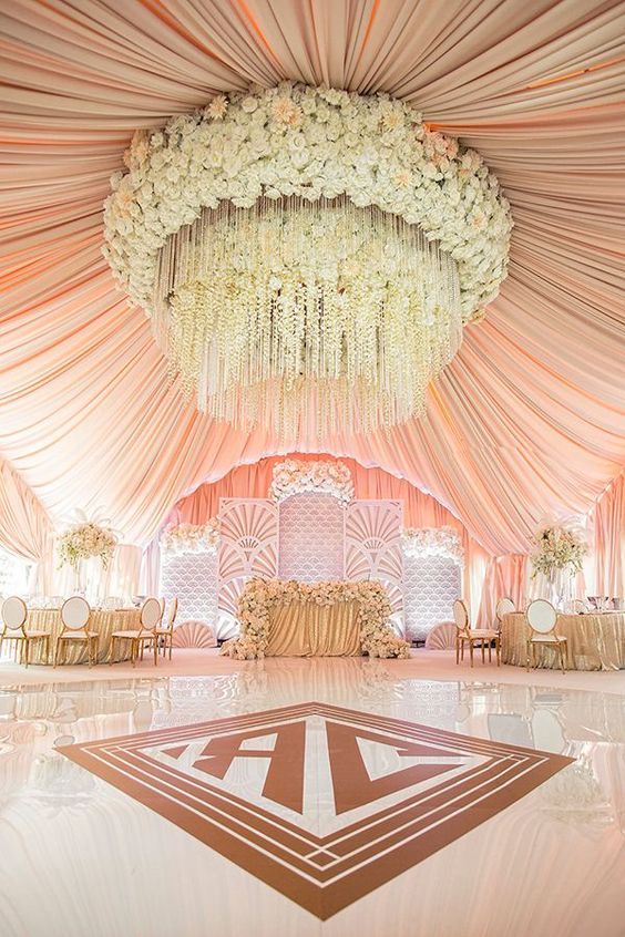 an image of a wedding venue with flowers on the ceiling and chandelier hanging from the ceiling