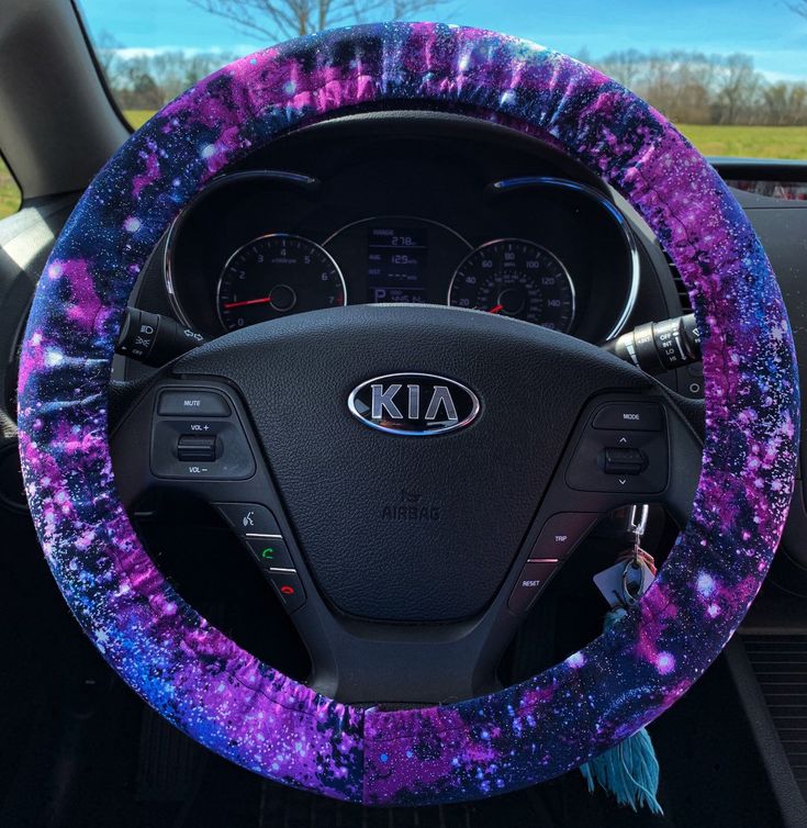 the steering wheel cover is covered in purple and blue paint