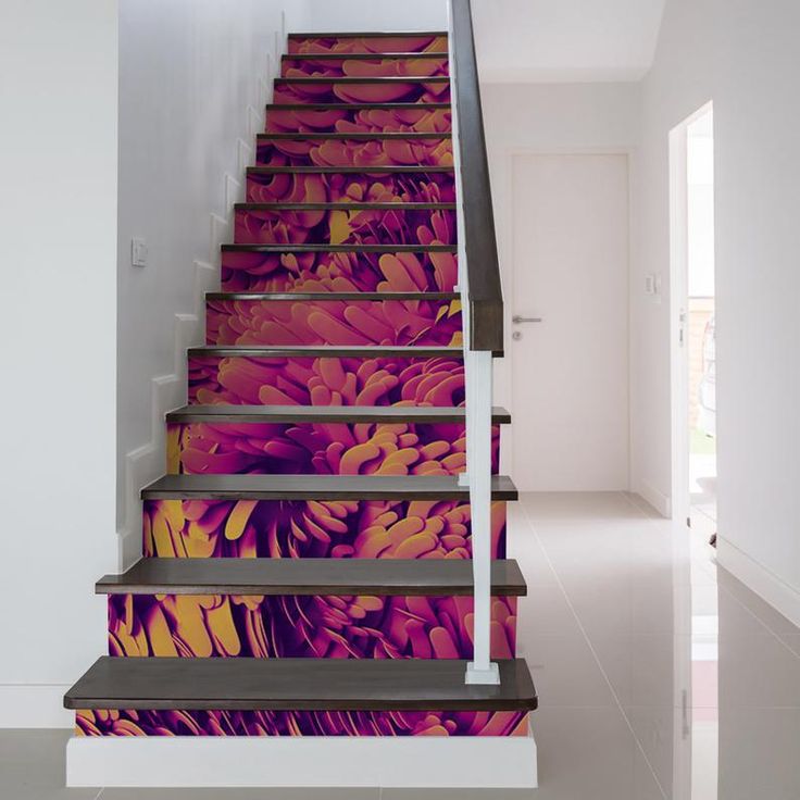 the stairs are painted with colorful flowers on them, and there is also a handrail