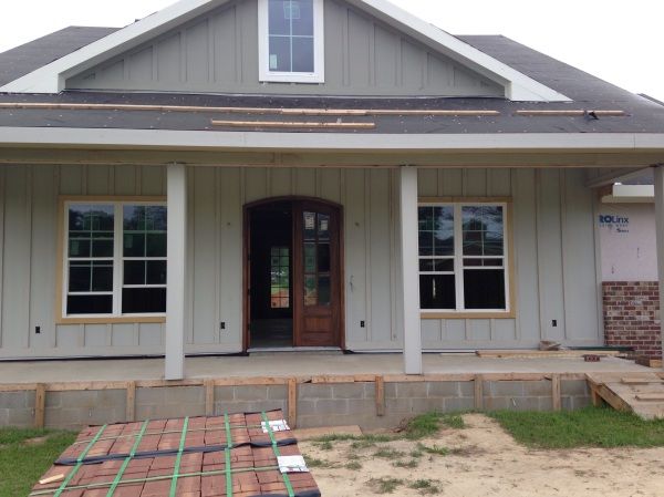 a house that is being built in the process of being remodeled with new siding and windows