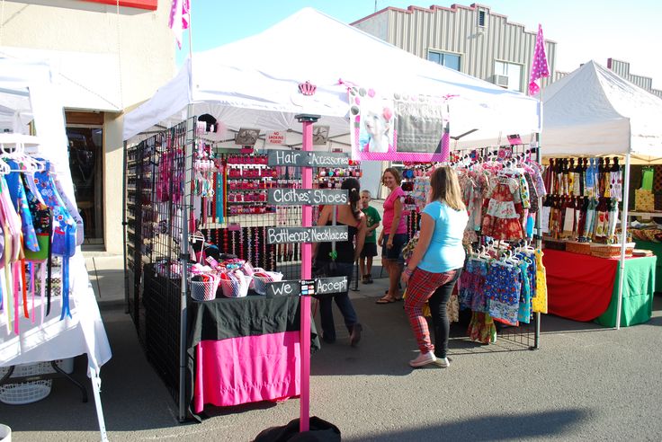 people are shopping at an outdoor flea market