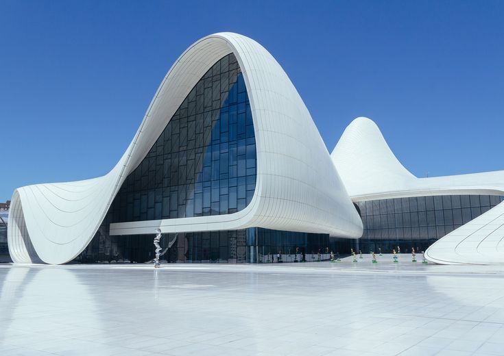 an architectural building with large curved windows on the outside