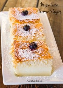 three pieces of cake with blueberries and powdered sugar on top