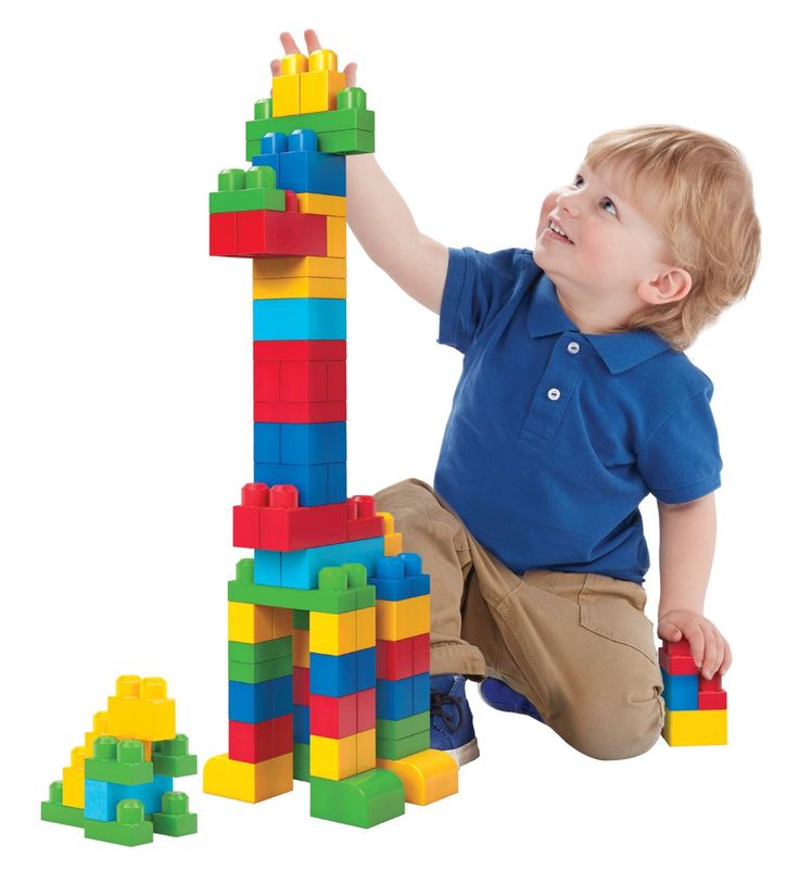 a young boy playing with blocks and toys