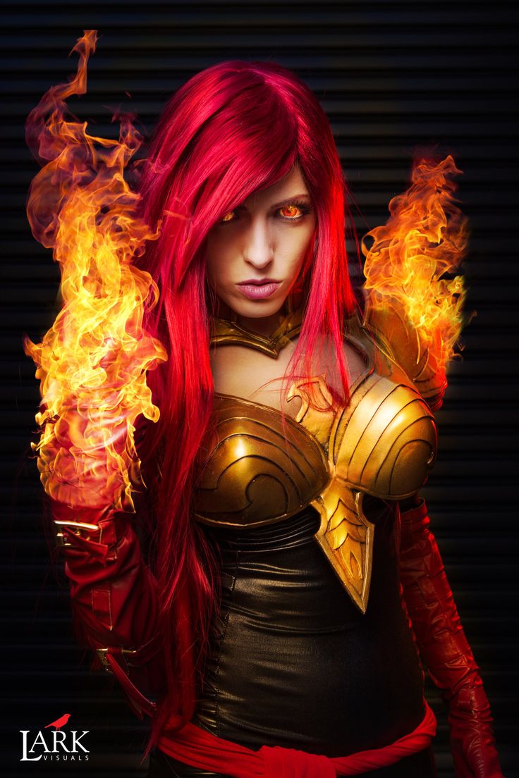 a woman with red hair and flames on her chest, wearing a cosplay costume