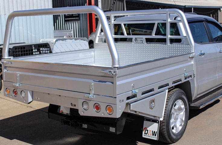 a silver truck parked in front of a building