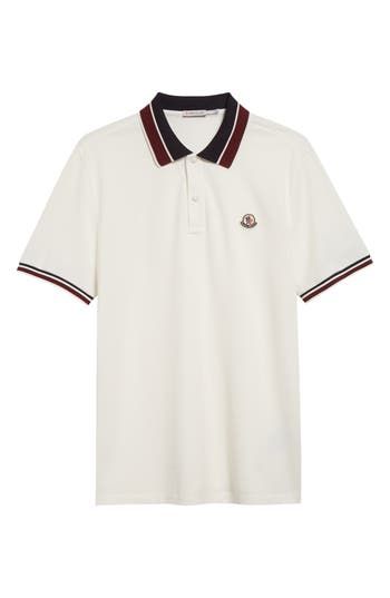 Two-tone stripes tip the spread collar and cuffs of this staple polo crafted of cotton piqué and branded with an iconic logo patch. Button half placket Spread collar Short sleeves 100% cotton Machine wash, dry flat Imported Designer Clothing Classic Short Sleeve Polo Shirt With Striped Cuffs, Classic White Polo Shirt With Ribbed Collar, Luxury Short Sleeve Polo Shirt With Striped Collar, Classic Polo Shirt With Contrast Stripes, Casual Polo Shirt With Embroidered Logo For Work, Casual Workwear Polo Shirt With Embroidered Logo, Collared Polo Shirt With Embroidered Logo For Work, Collared Polo Shirt With Embroidered Logo, Classic Polo Shirt With Signature Stripes