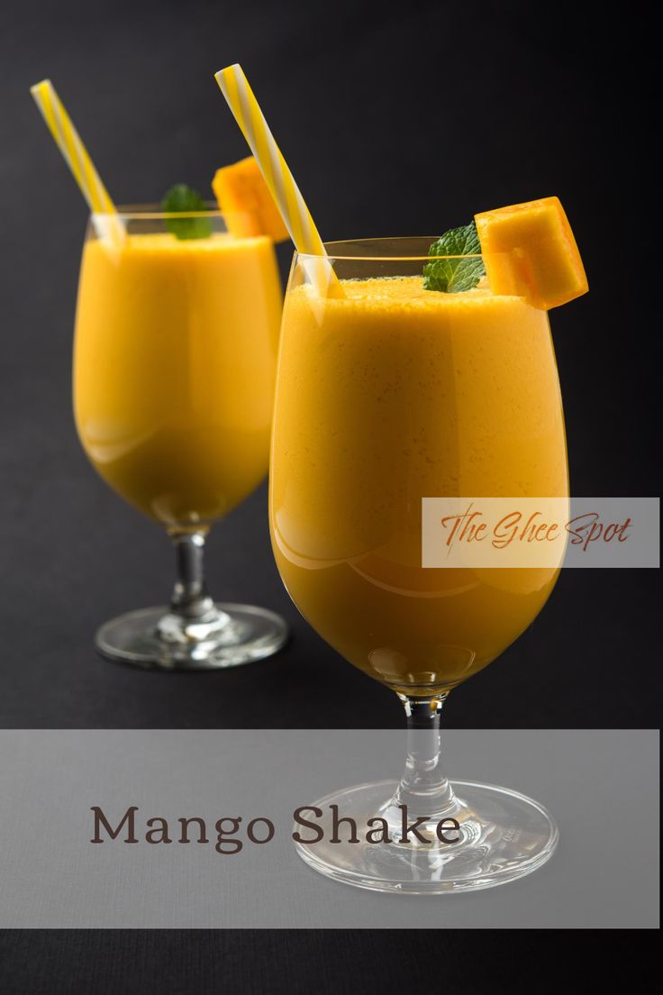 two glasses filled with orange juice and garnished with mint