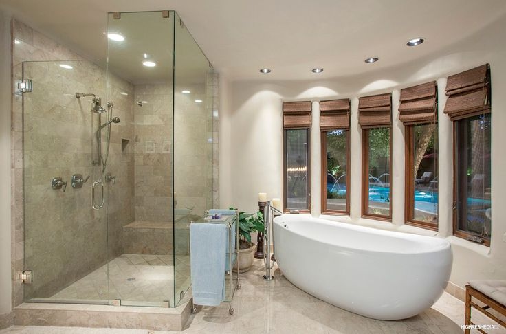 a bathroom with a large tub and two windows