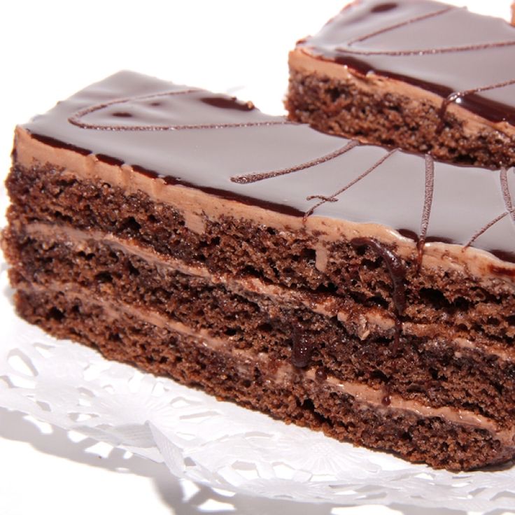 three slices of chocolate cake sitting on top of each other