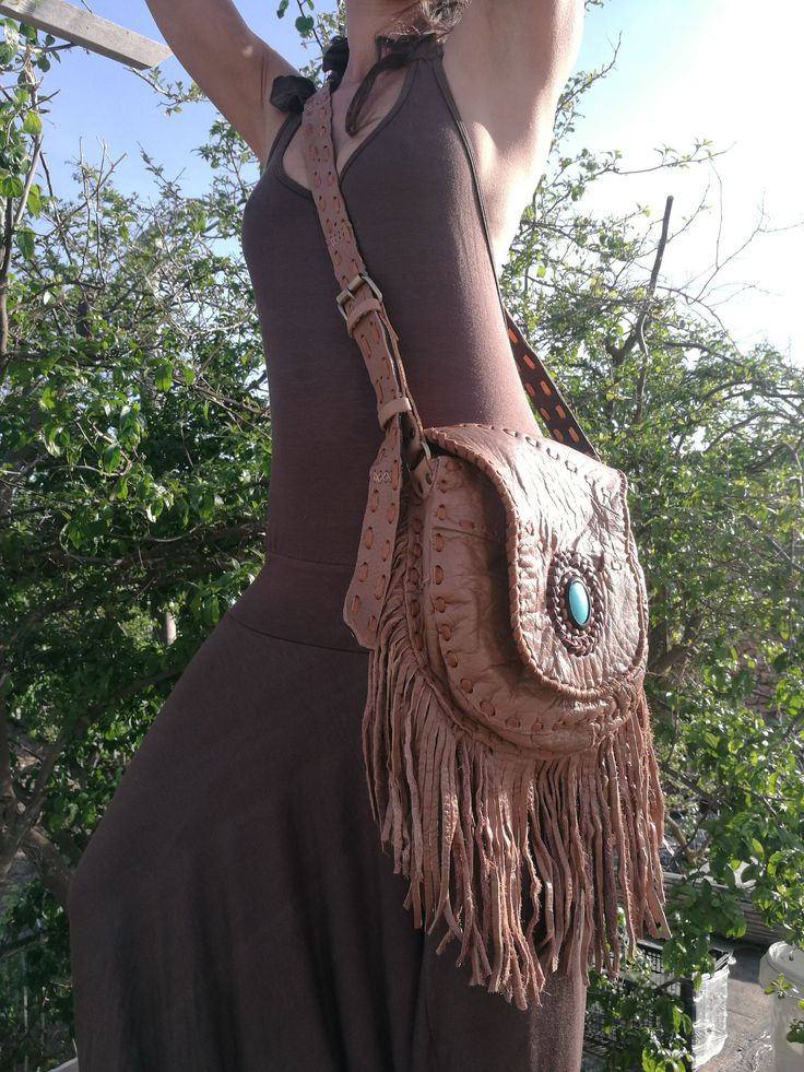 "Boho purse, Leather Fringe Bag, Fringe shoulder Bag, Brown Leather, Turquoise Stone, Hippie Bag, Boho Bag, Ibiza Bag, Handmade Bag Light Brown leather bag with fringe and Turquoise Stone Fully lined inside with one pocket and a inside pocket with zip. Strap can be adjustable to several lengths. Handmade and the best finishing quality. Dimensions: Main pocket with brass magnet: [10\"X9.5\"] or [26cmX24cm] Inside zipper pocket: [5\"x5\"] or [13x13cm] Fringe [8.5\"] or [22cm] Notes: 1) Since every Native Culture, Leather Fringe Bag, Boho Purse, Brown Cow, Hippie Bags, Shoulder Bag Brown, Light Brown Leather, Boho Purses, Fringe Bags