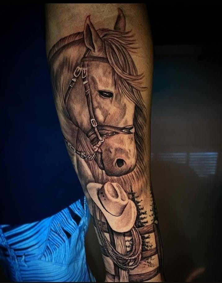 a man with a horse tattoo on his leg