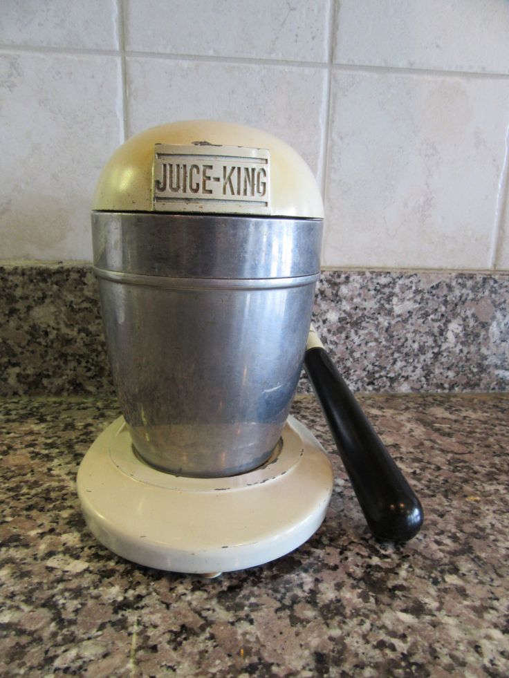 a juice - king blender sitting on top of a granite countertop next to a spatula