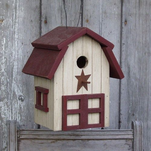 a bird house with a star on the roof