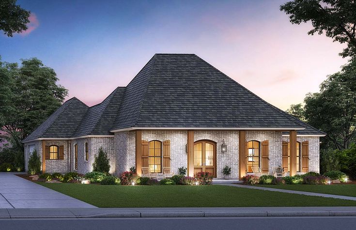 this is a computer rendering of the front elevation of a house at dusk with lights on