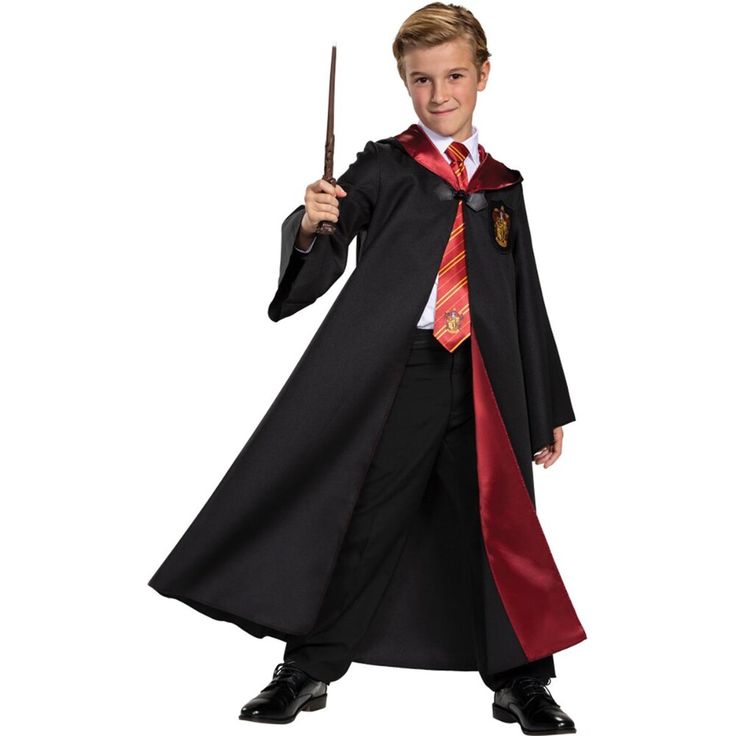 a young boy dressed as harry potter holding a wand and wearing a black robe with red trim