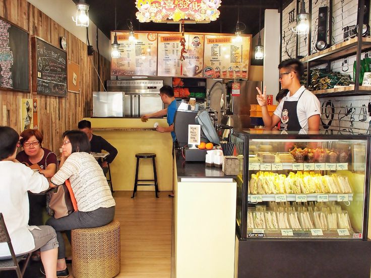 people sitting at tables in a small restaurant