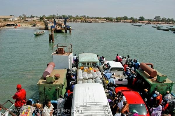 a group of people standing on the side of a boat in water next to a dock