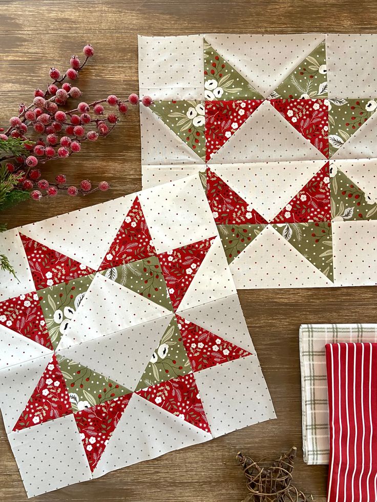 two red and white quilts sitting on top of a wooden table next to each other