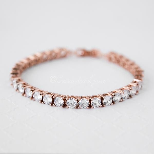 Glamorous and chic, set in an array of round cut CZ on rose gold plating. This simply gorgeous cubic zirconium bracelet is breath-taking. Perfect for weddings, Rose Gold Tennis Bracelet With Cubic Zirconia, Dazzling Rose Gold Wedding Bracelets, Dazzling Rose Gold Bracelets With Sparkling Stones, Elegant Rose Gold Cubic Zirconia Diamond Bracelet, Rose Gold Diamond Bracelet With Accents For Wedding, Rose Gold Hand Set Tennis Bracelet For Wedding, Luxury Rose Gold Tennis Bracelet For Wedding, Dazzling Rose Gold Tennis Bracelet With Cubic Zirconia, Dazzling Rose Gold Cubic Zirconia Tennis Bracelet