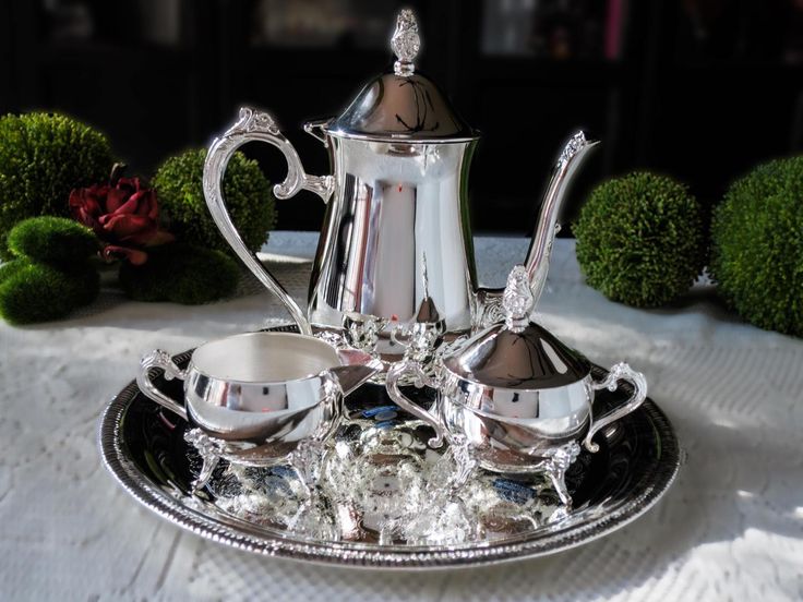 a silver tea set sitting on top of a table