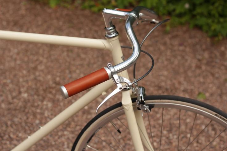 a close up of a bike with a red handlebar on it's front wheel