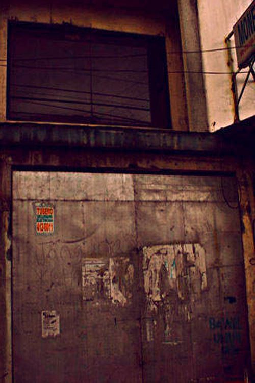 an old garage door with graffiti on it