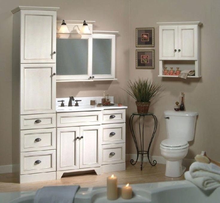 a bathroom with white cabinets and a toilet