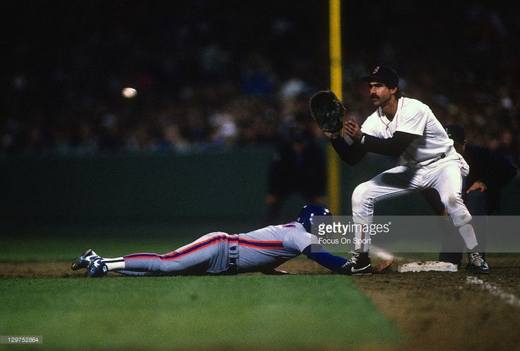 the baseball player is trying to slide into home plate as the catcher and umpire look on